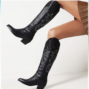 Knee high black cowboy boots with white embroidery